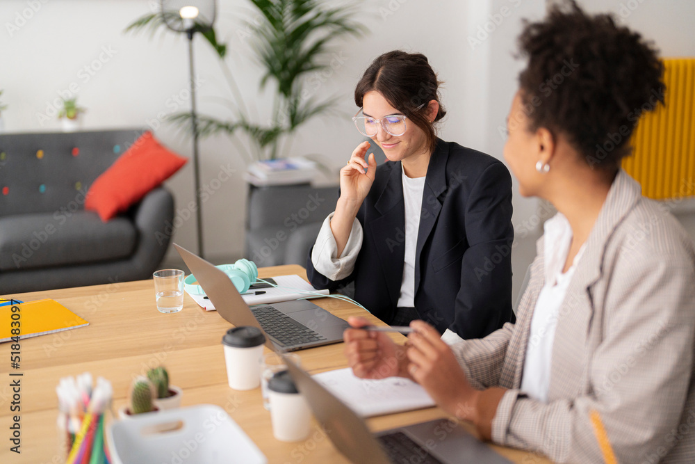 Young designer considering ideas of colleague Young designer considering ideas of colleague