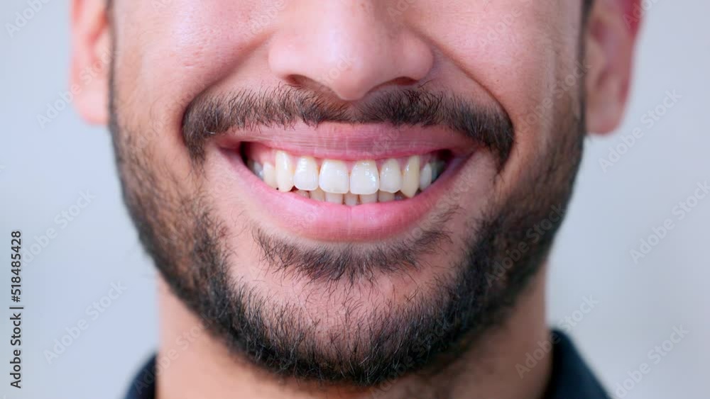 The natural smile of a friendly architect satisfied with the work he has done. The face of a happy young planner smiling in the delight of his success at work. A joyful guys teeth with a beard The natural smile of a friendly architect satisfied with the work he has done. The face of a happy young planner smiling in the delight of his success at work. A joyful guys teeth with a beard