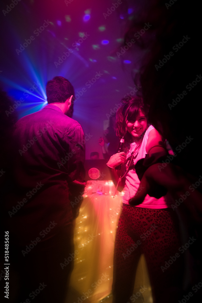 Smiling woman dancing at the party pointing at camera Smiling woman dancing at the party pointing at camera