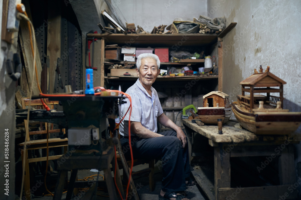 Older Asian Man Works On His Model Boats At His Workshop. Older Asian Man Works On His Model Boats At His Workshop.