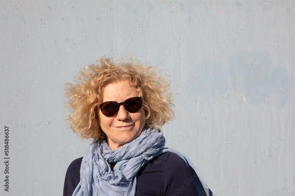 attractive sixty years old woman with blonde curly hair attractive sixty years old woman with blonde curly hair