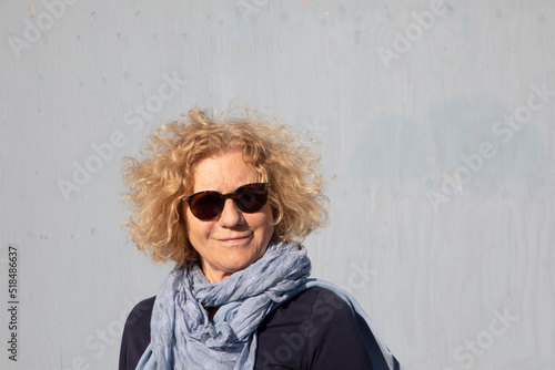  attractive sixty years old woman with blonde curly hair