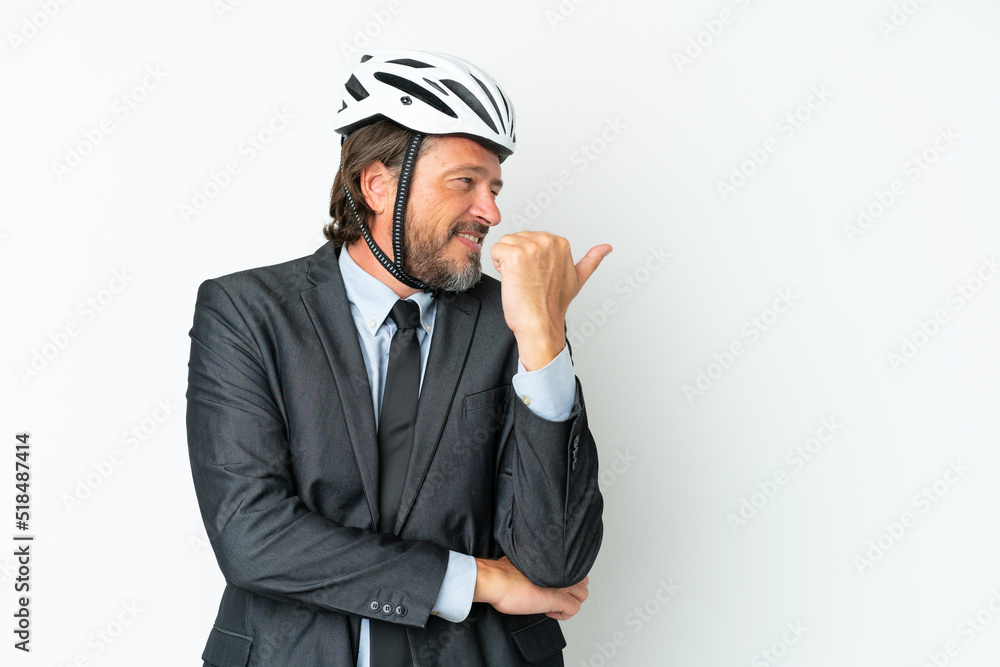 Business senior man with a bike helmet isolated on white background pointing to the side to present a product Business senior man with a bike helmet isolated on white background pointing to the side to present a product