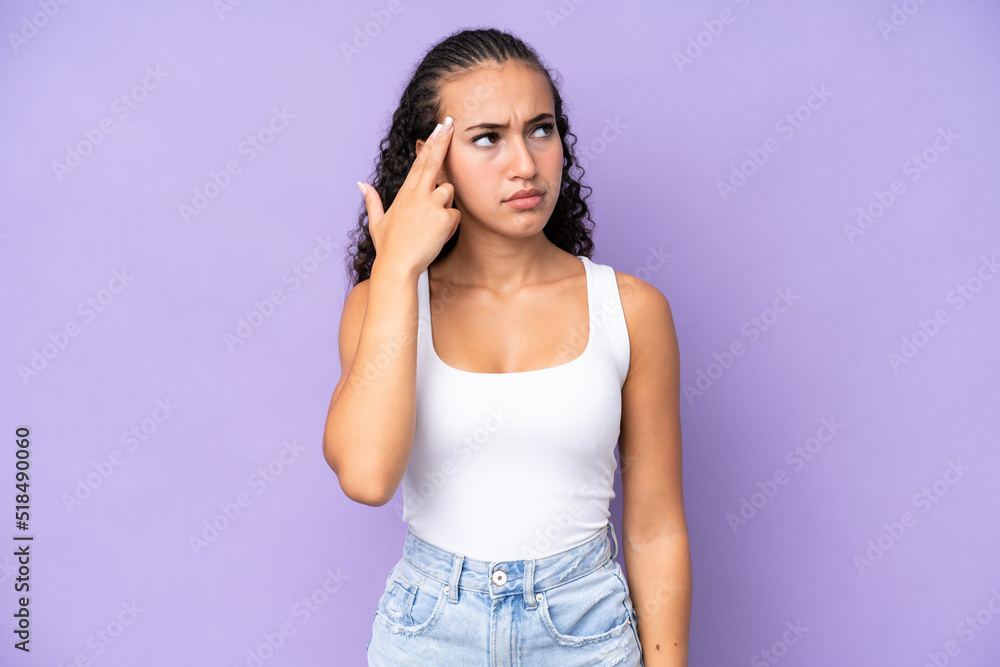 Young woman isolated on purple background with problems making suicide gesture Young woman isolated on purple background with problems making suicide gesture