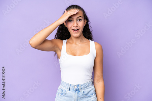 Young woman isolated on purple background has realized something and intending the solution