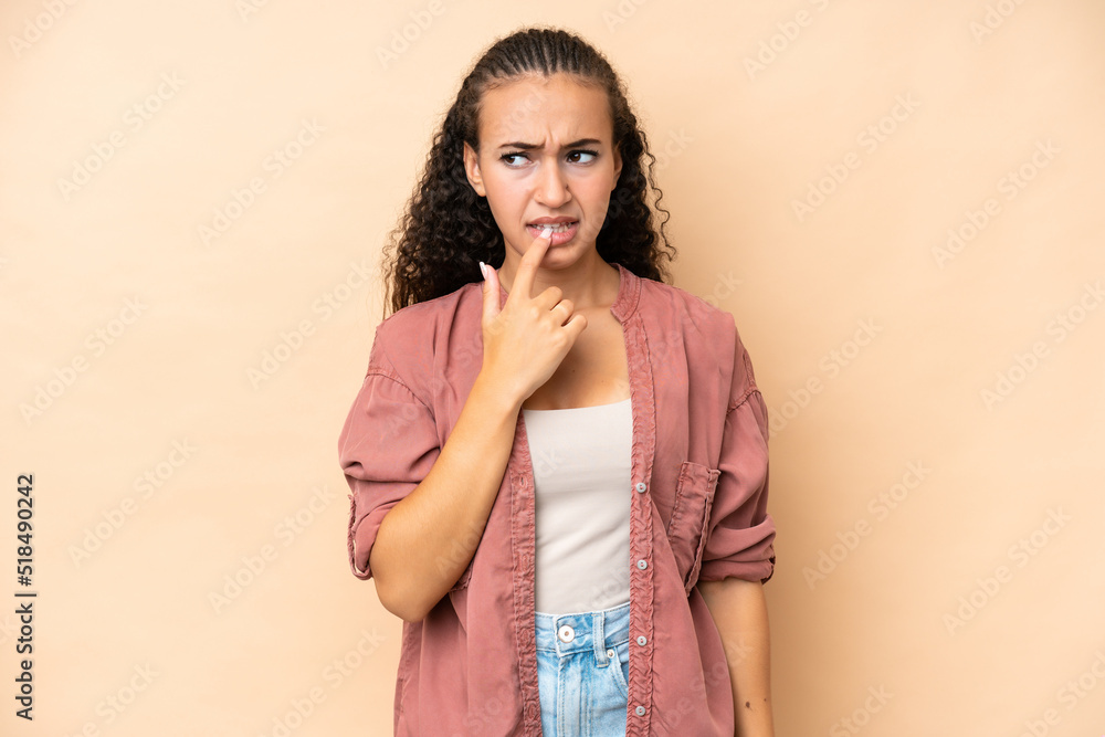 Young woman isolated on beige background nervous and scared Young woman isolated on beige background nervous and scared