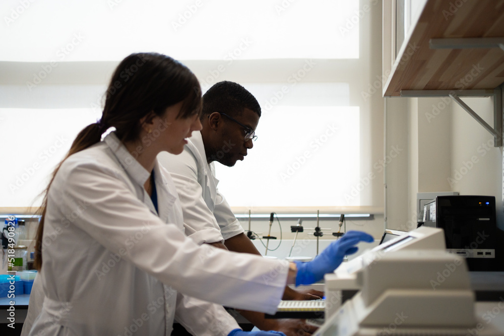 Multiracial Scientists Researching In The Laboratory. Multiracial Scientists Researching In The Laboratory.