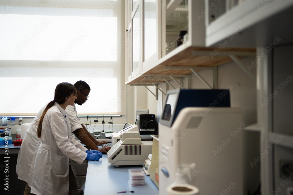 Multiracial Scientists Working Together In The Laboratory. Multiracial Scientists Working Together In The Laboratory.