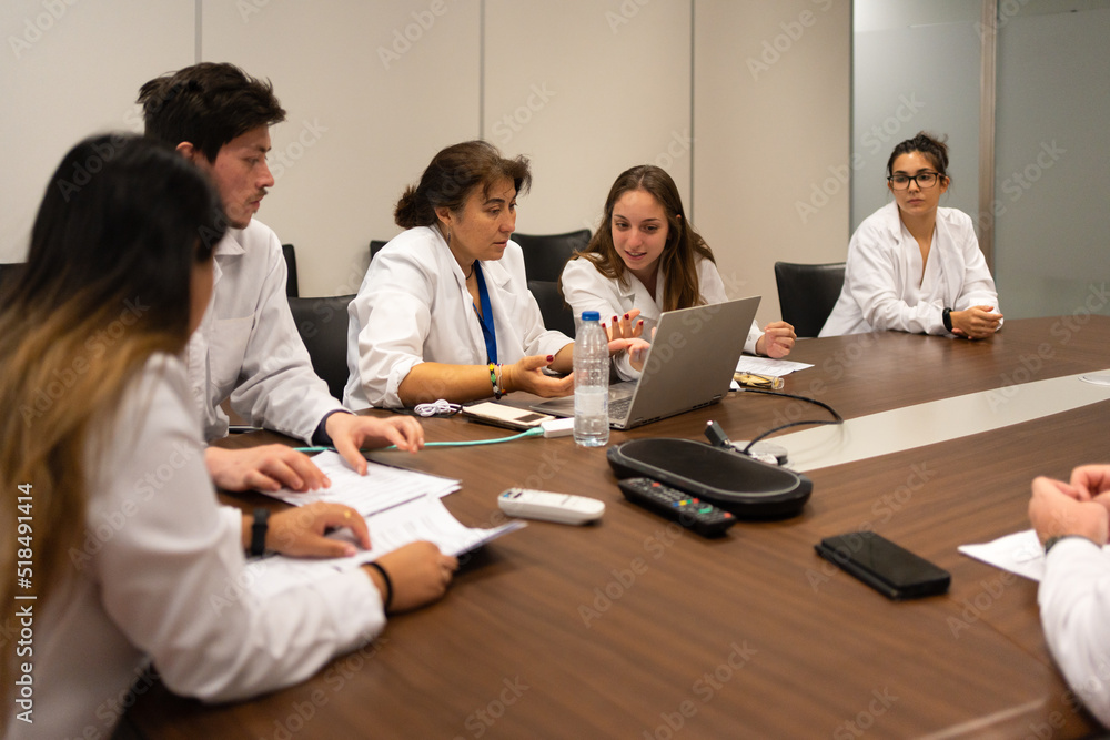 Meeting Of Scientists Discussing Sitting Around The Table. Meeting Of Scientists Discussing Sitting Around The Table.