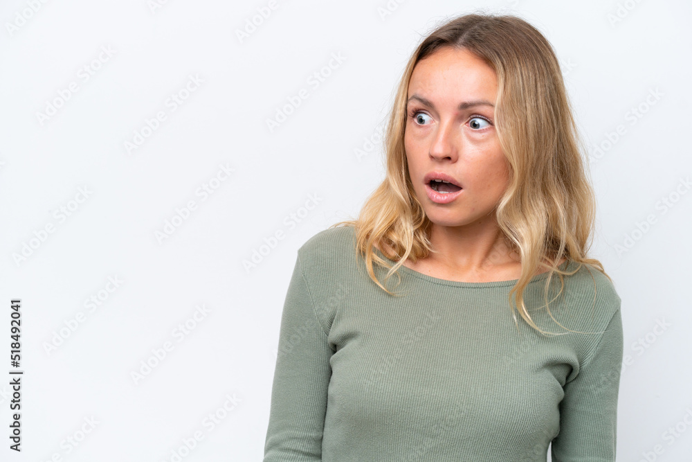 Young Russian woman isolated on white background doing surprise gesture while looking to the side Young Russian woman isolated on white background doing surprise gesture while looking to the side