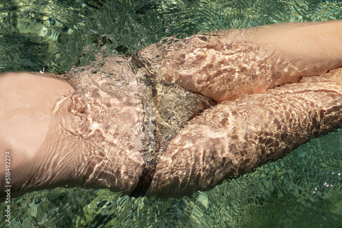 sexy wet body in green sea water