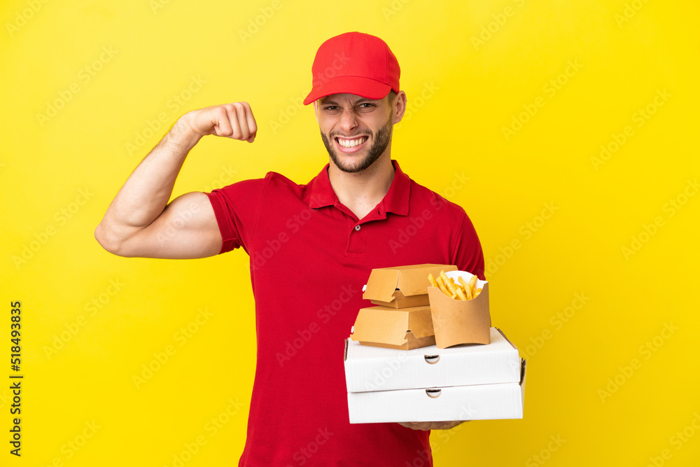 pizza delivery man picking up pizza boxes and burgers over isolated background doing strong gesture pizza delivery man picking up pizza boxes and burgers over isolated background doing strong gesture