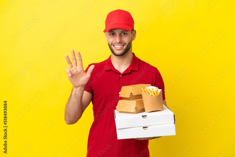 pizza delivery man picking up pizza boxes and burgers over isolated background happy and counting four with fingers pizza delivery man picking up pizza boxes and burgers over isolated background happy and counting four with fingers