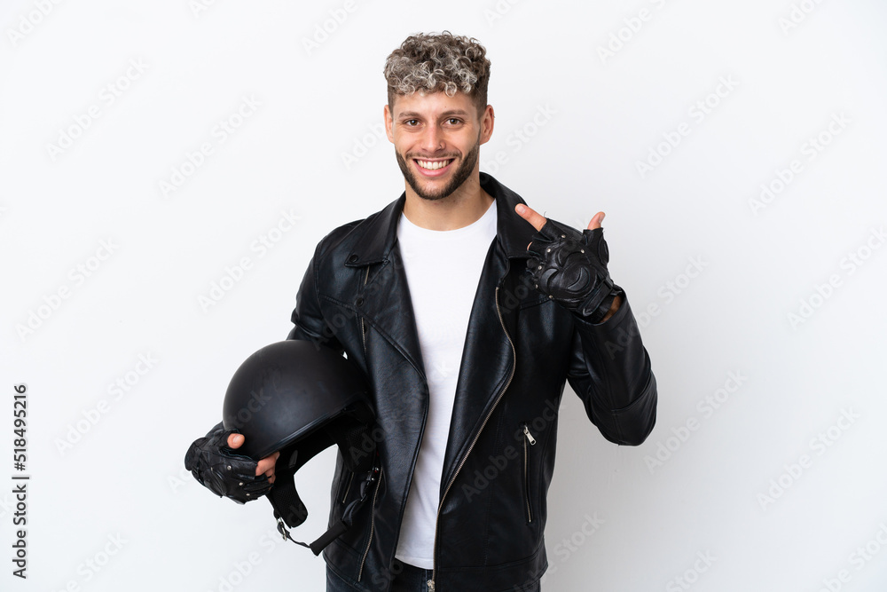 Young man with a motorcycle helmet isolated on white background giving a thumbs up gesture Young man with a motorcycle helmet isolated on white background giving a thumbs up gesture