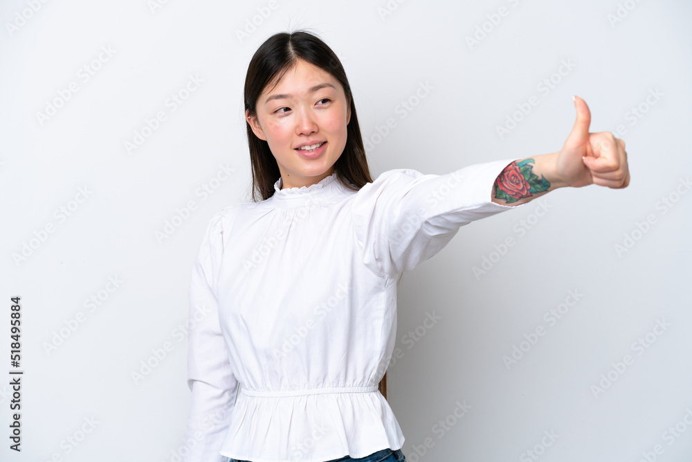 Young Chinese woman isolated on white background giving a thumbs up gesture Young Chinese woman isolated on white background giving a thumbs up gesture