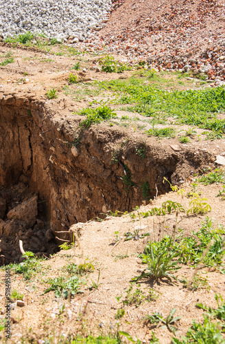 the corner of a dig hole in stony earth