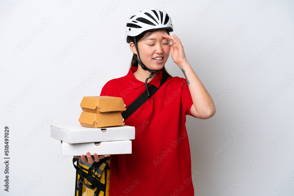 Young Chinese delivery woman taking takeaway food isolated on white background smiling a lot Young Chinese delivery woman taking takeaway food isolated on white background smiling a lot