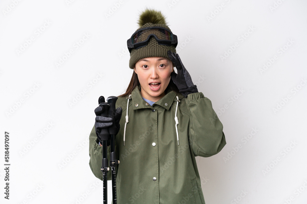 Young Chinese woman wearing winter jacket isolated on white background with surprise expression Young Chinese woman wearing winter jacket isolated on white background with surprise expression
