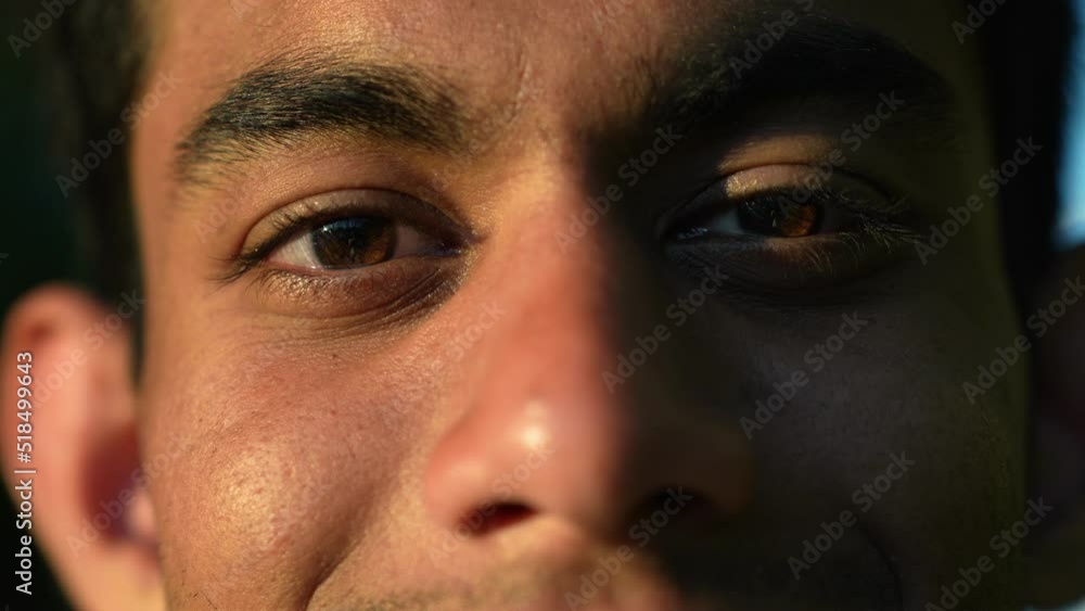 Extreme Close up of face of young Srilankan man smiling through his eyes looking at camera. Extreme Close up of face of young Srilankan man smiling through his eyes looking at camera.