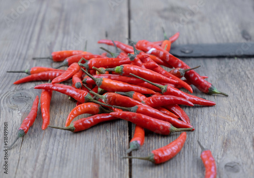 Close up fresh red hot chilli on wooden table background.