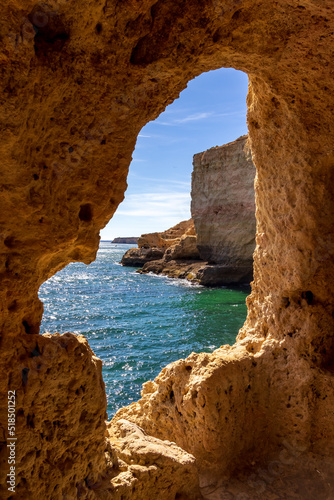 View from the Boneca s Cave to the ocean. A sunny day on the coast of Lagoa  Algarve  Portugal