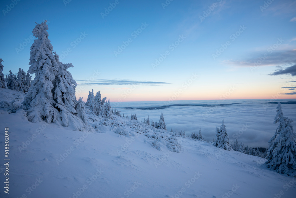 Early winter morning in the mountains. Magnificent view of sky above clouds Early winter morning in the mountains. Magnificent view of sky above clouds
