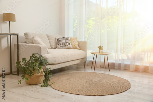 Photography Beautiful sunlit living room with stylish sofa