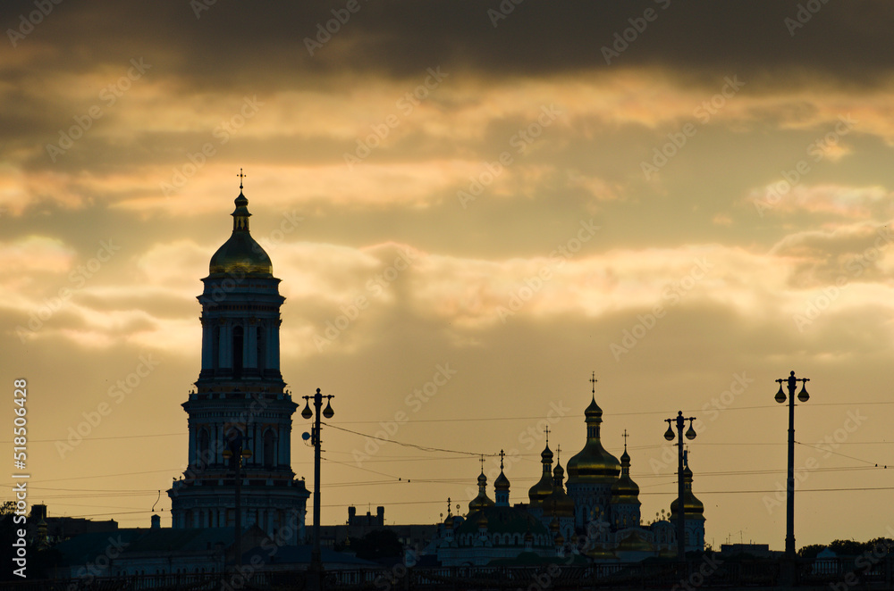 Picturesque view black silhouette of Kyiv Pechersk Lavra against stormy sky and gloomy clouds. It is a historic Orthodox Christian monastery. UNESCO World Heritage Site