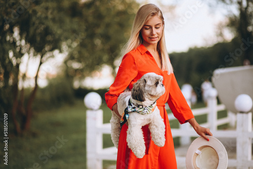 Pretty woman with her cute dog on vacation