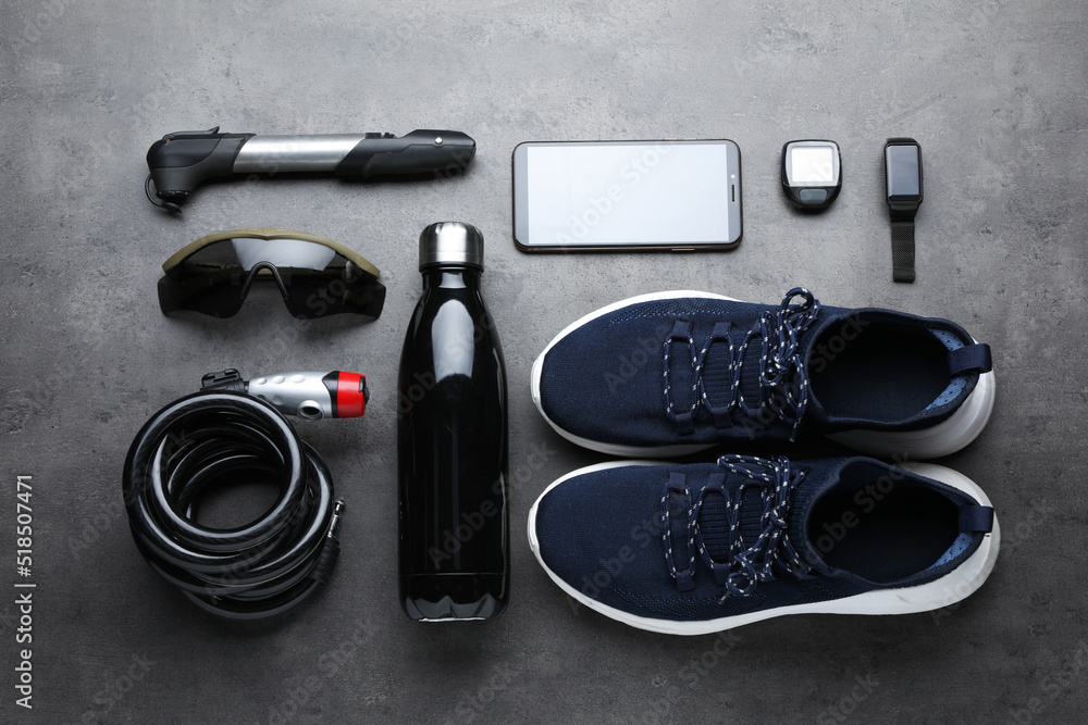 Flat lay composition with different cycling accessories on grey background Flat lay composition with different cycling accessories on grey background