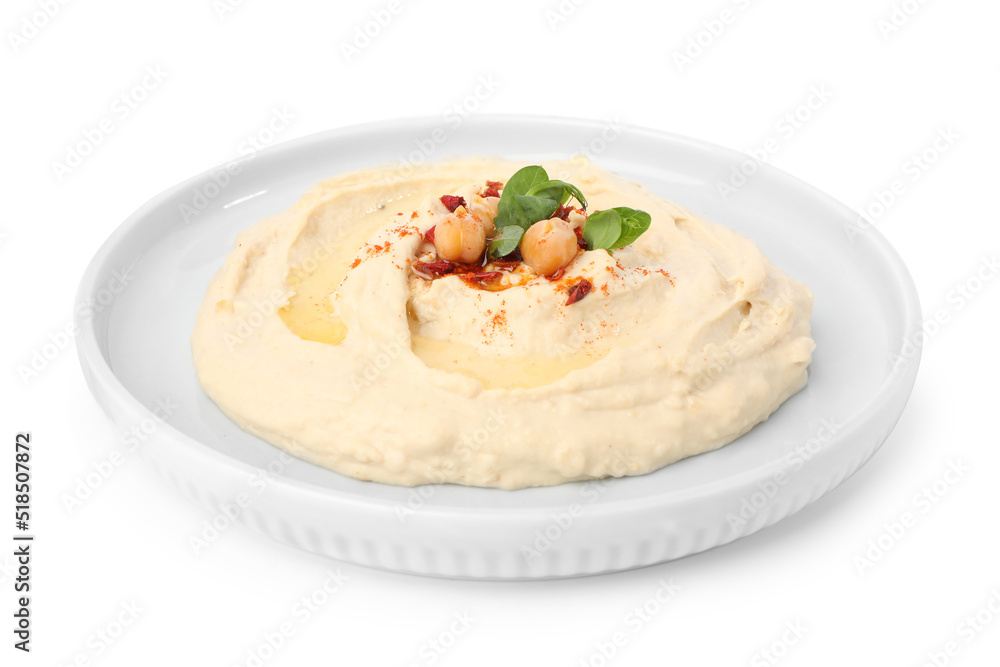 Plate of tasty hummus with garnish isolated on white