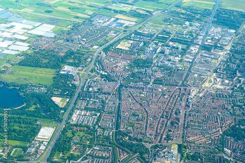 Aerial view of lake   modern city with roads and skyscrapers from airplane. Amsterdam  North Holland  Netherlands