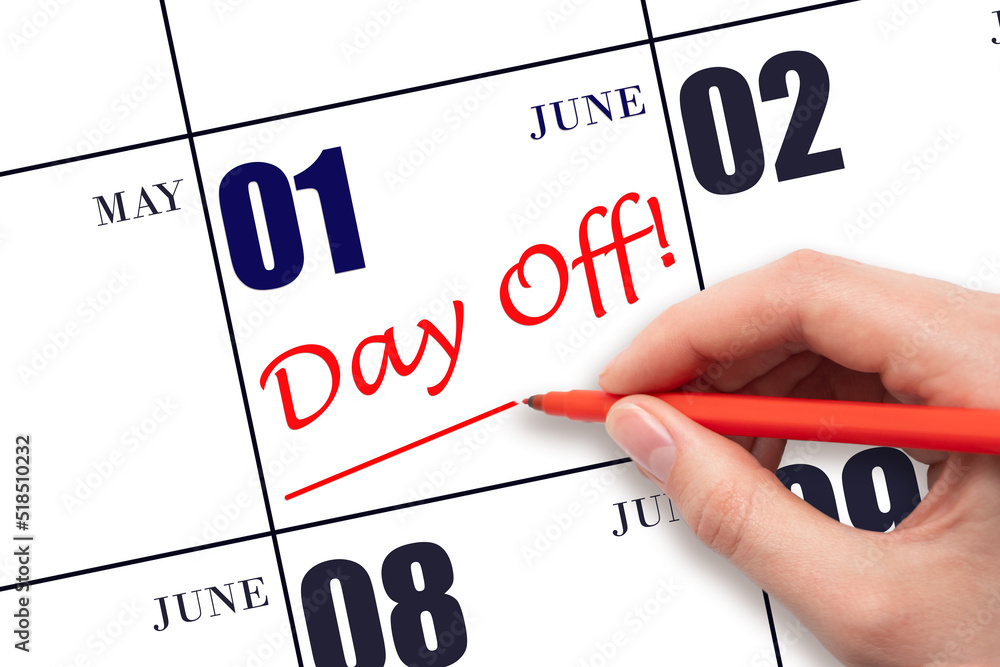 1st day of June. Hand writing text DAY OFF and drawing a line on calendar date 1 June. Vacation planning concept. Summer month, day of the year concept. 1st day of June. Hand writing text DAY OFF and drawing a line on calendar date 1 June. Vacation planning concept. Summer month, day of the year concept.