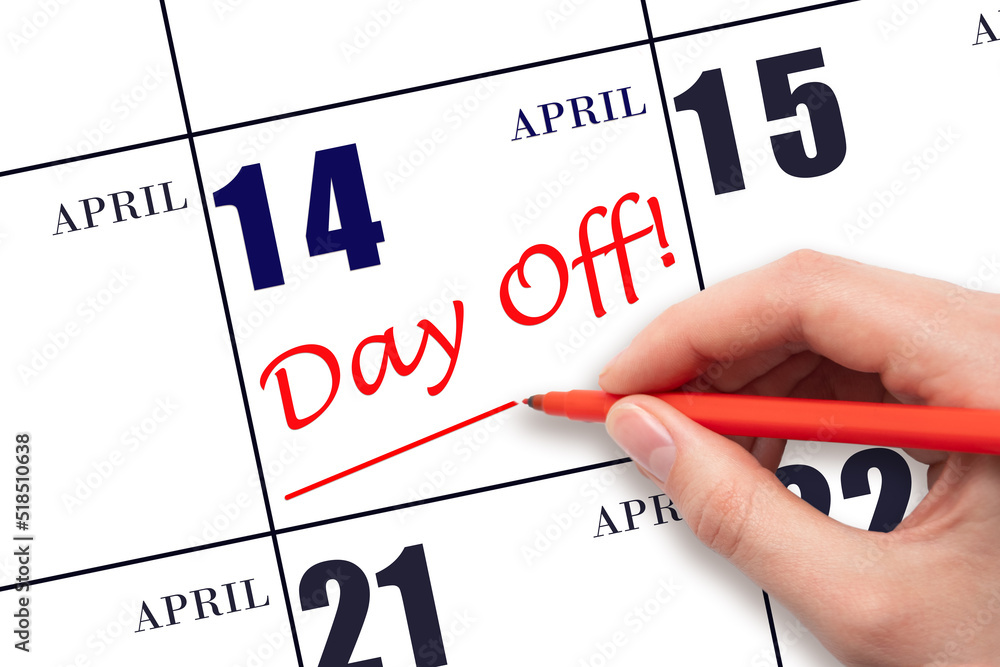 14th day of April. Hand writing text DAY OFF and drawing a line on calendar date 14 April. Vacation planning concept. Spring month, day of the year concept. 14th day of April. Hand writing text DAY OFF and drawing a line on calendar date 14 April. Vacation planning concept. Spring month, day of the year concept.