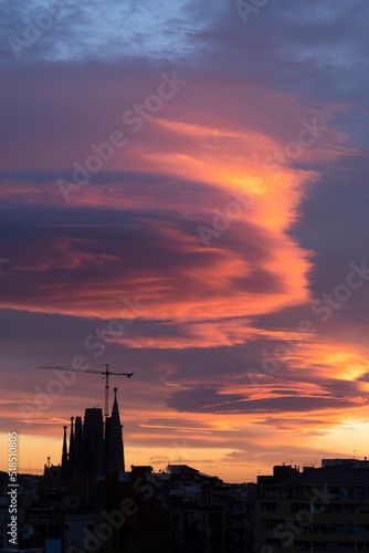 Silhouette of the Sagrada Familia in Barcelona at sunset with curious cloud formation.