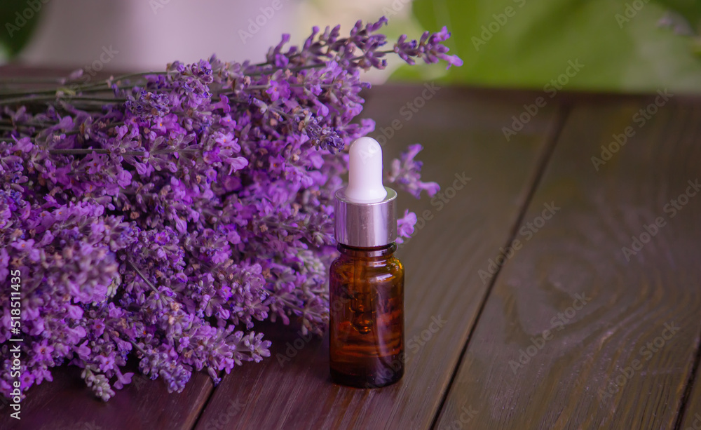 Essential oil of lavender, on a wooden background. Essential oil of lavender, on a wooden background.