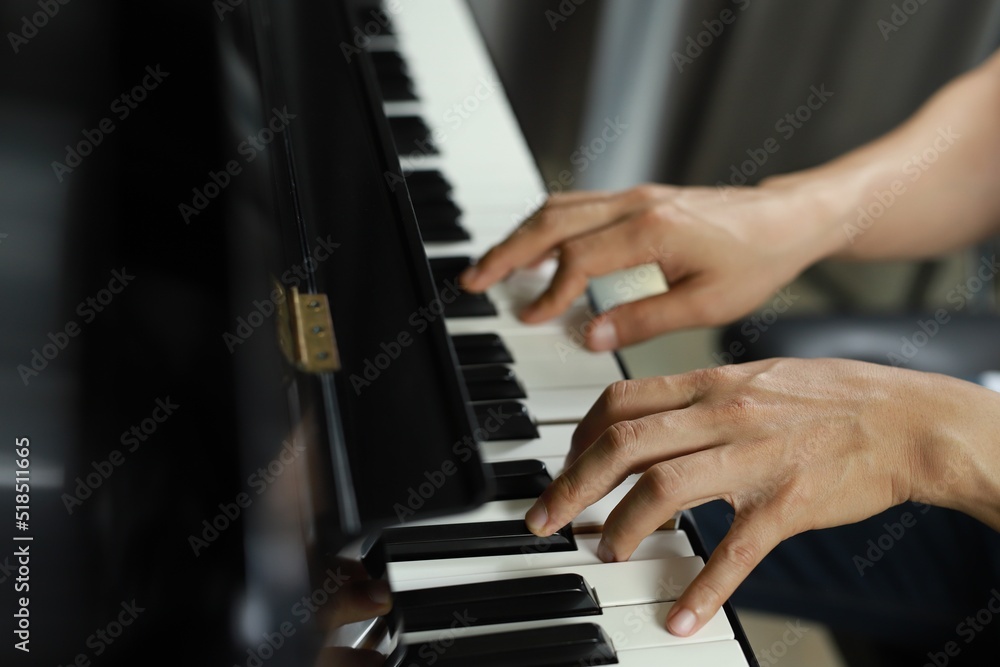 Obraz premium side photo A man plays the piano in the music room at school. favorite classical music