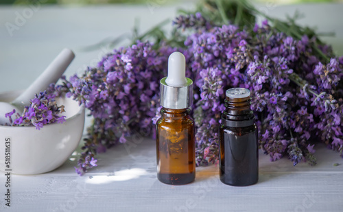 Essential oil of lavender  on a wooden background.