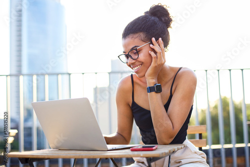 Freelace worker lifestyle. Young beautuful girl working on laptop outside photo