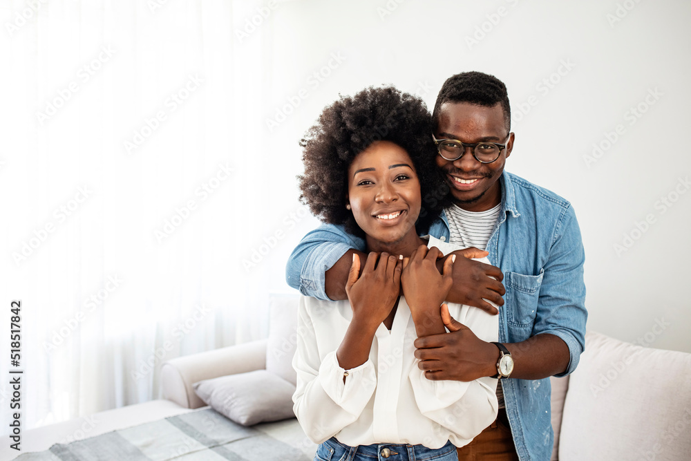 Foto Stock Portrait of happy african american couple hugging at home ...