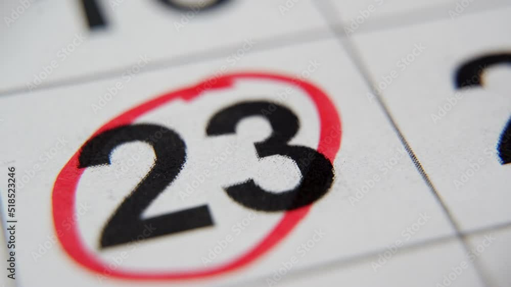 The calendar 23rd day of the month is circled. A red marker circles the twenty-third day of the month from the paper calendar. A very important date in the calendar The calendar 23rd day of the month is circled. A red marker circles the twenty-third day of the month from the paper calendar. A very important date in the calendar
