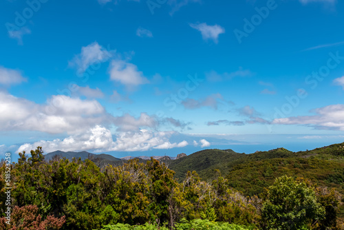 Scenic view on the forest in Garajonay National Park. Lookout from summit of Alto de Garajonay, La Gomera, Canary Islands, Spain, Europe. Hiking trail from Roque de Agando. Atlantic Ocean