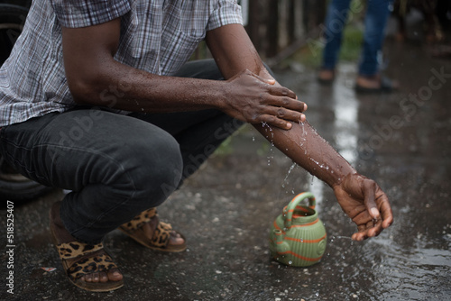 Muslim man washes his hands before prayer ritual cleansing. Islamic religious rite