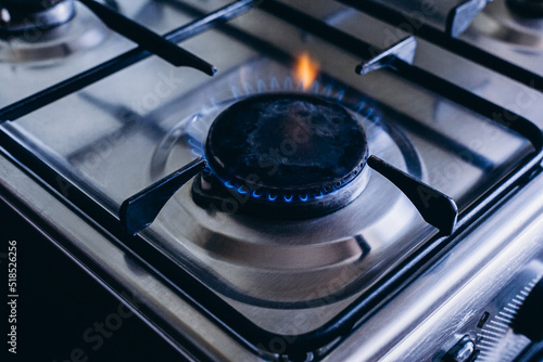 Kitchen gas hob, stove cook with blue and orange flames burning