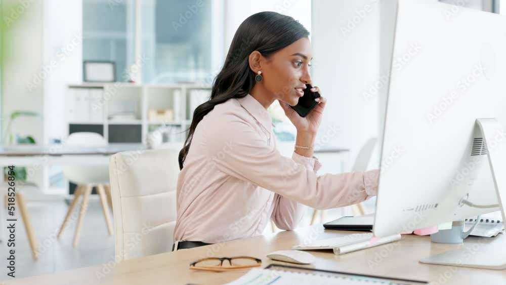 Business woman talking on a phone while working on a computer in an office. Dedicated and happy young professional communicating project plans and discussing deals with clients in a startup company Business woman talking on a phone while working on a computer in an office. Dedicated and happy young professional communicating project plans and discussing deals with clients in a startup company
