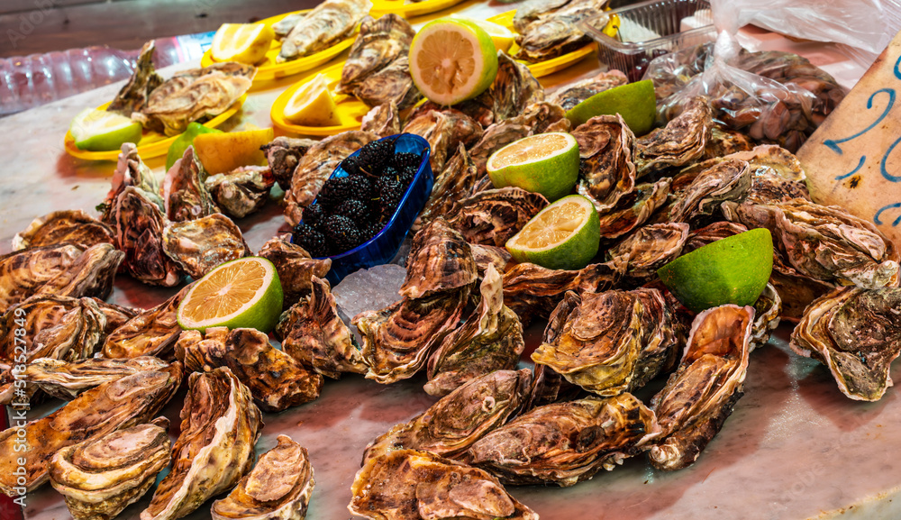 gourmet ousters closeup on a table with lemon, seafood market , sea goods on trading floor, lifestyle of a marine port gourmet ousters closeup on a table with lemon, seafood market , sea goods on trading floor, lifestyle of a marine port