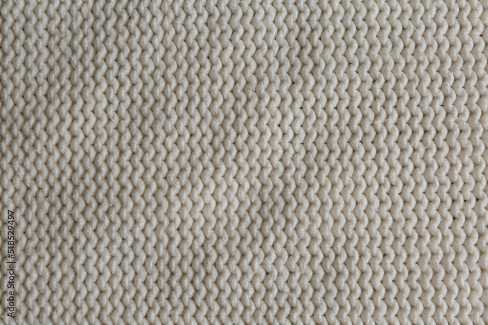 Beautiful white knitted fabric as background, top view Beautiful white knitted fabric as background, top view