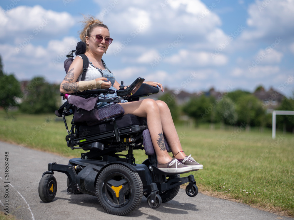Woman in electric wheelchair going on walk