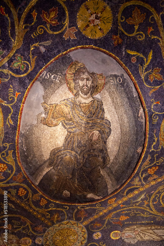An ancient fresco depicting a saint on the walls of the Church of the Holy Sepulcher. A beautiful and detailed icon made of small colored pebbles. The face of a saint