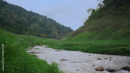 Slow motion waterfall Ton Nam Green Mountain with meadow and river at Khun Dan Prakarn Chon Dam Nakhon Nayok Thailand. photo